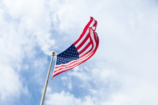 American flag against cloudy sky