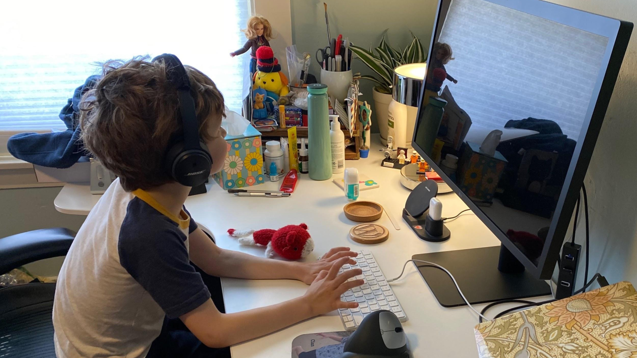 My son pretending to work at my desk