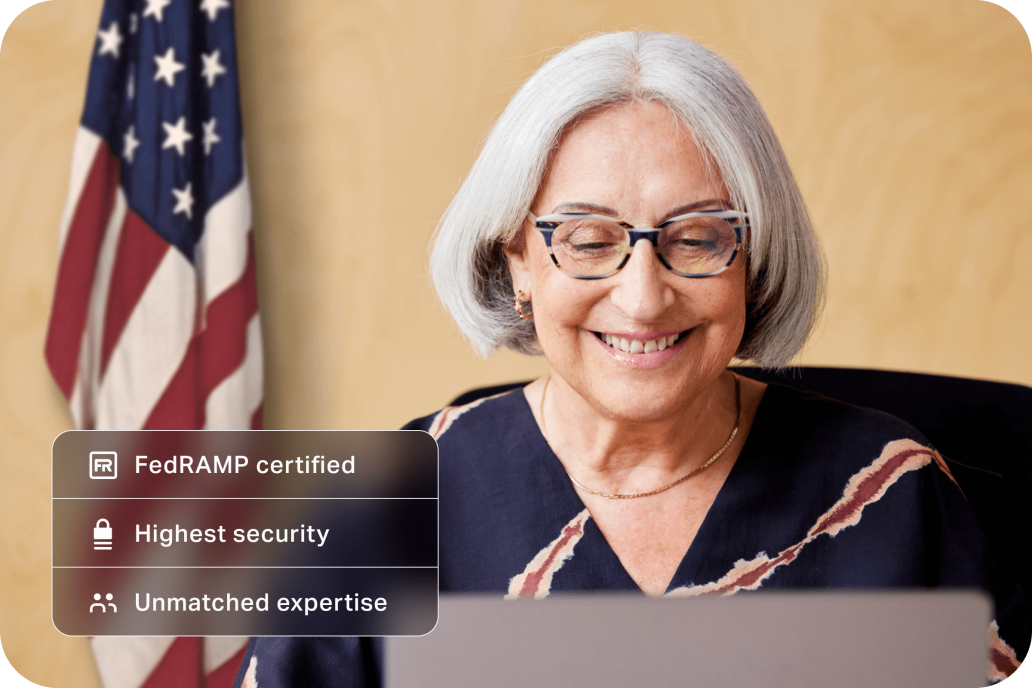 Government worker smiling contently at her laptop in her office